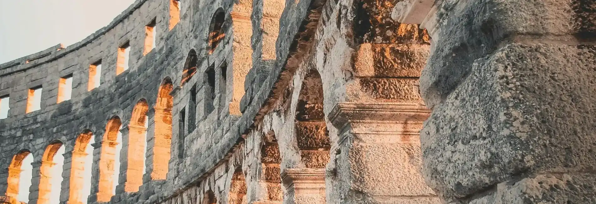 Sunlit arches inside the Roman Colosseum